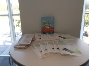 Table with flyers and Dr. Suess book for children's story hour at Map Mosaic: From Queens to the World, Queens Museum, NY