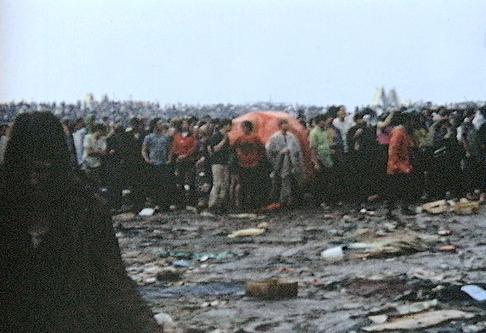 The audience at Woodstock waits for the rain to end, image by Derek Redmond and Paul Campbell, 1969 via Wikimedia Commons, https://commons.wikimedia.org/wiki/Woodstock#/media/File:Woodstock_redmond_rain.JPG
